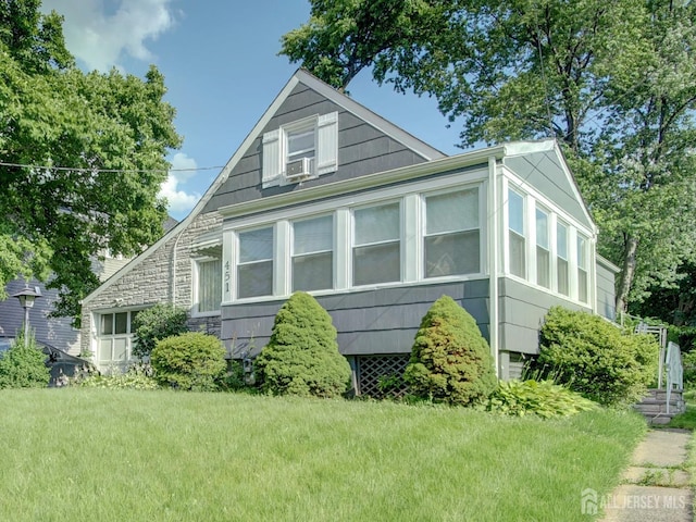 451 Burroughs Ter, Union Twp, NJ 07083 - view of front facade with a front lawn, cooling unit, and stone siding