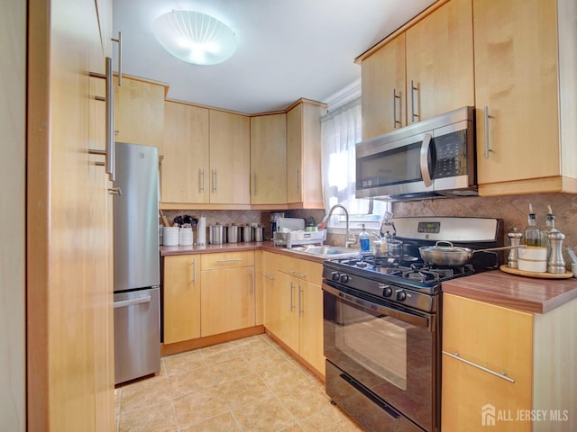 451 Burroughs Ter, Union Twp, NJ 07083 - kitchen featuring stainless steel appliances, light brown cabinetry, and tasteful backsplash