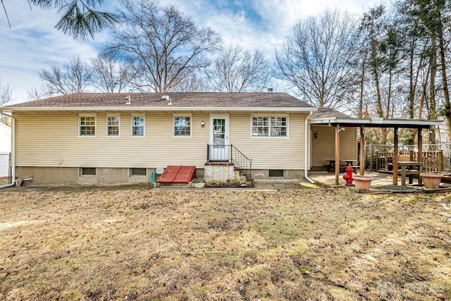 back of property with a lawn and a patio