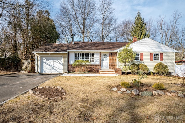 ranch-style house featuring driveway, a chimney, an attached garage, fence, and brick siding