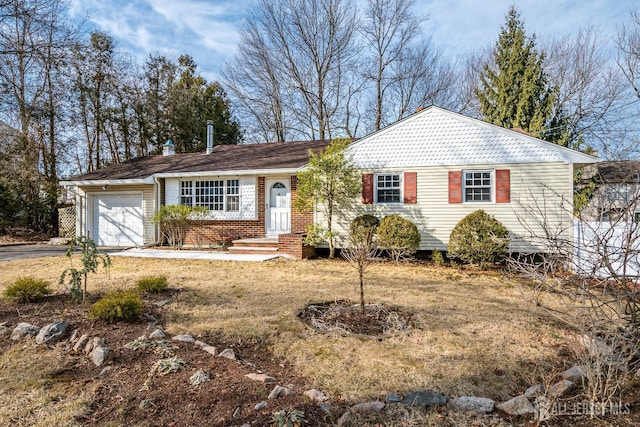 single story home with a garage, driveway, and brick siding