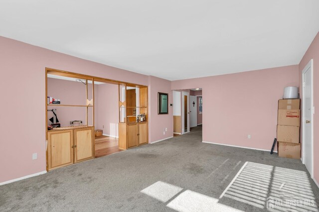 unfurnished living room with carpet floors