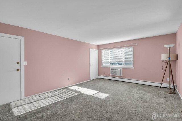 empty room featuring carpet floors, a wall mounted AC, and a baseboard heating unit