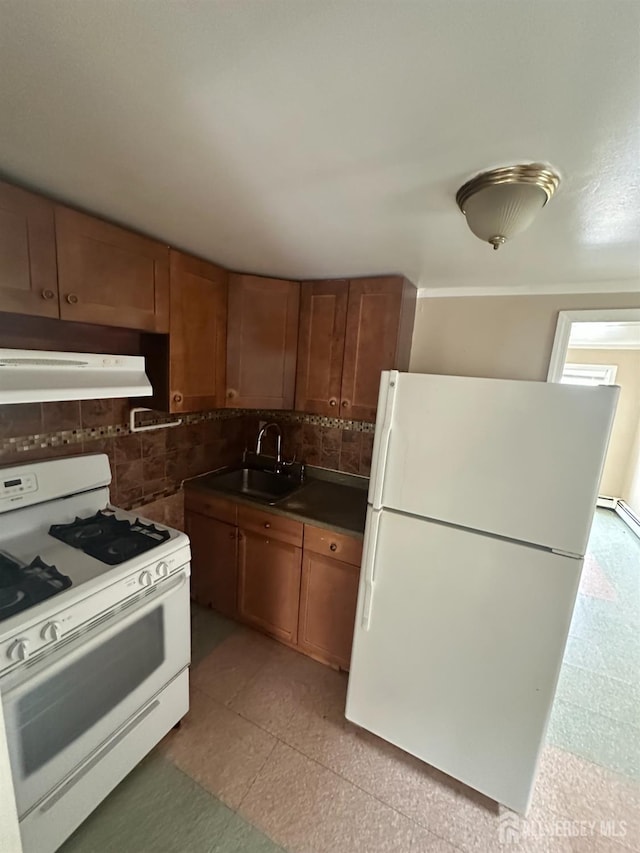 146 Seaman St, New Brunswick, NJ 08901 - kitchen featuring white appliances, under cabinet range hood, brown cabinets, backsplash, and dark countertops