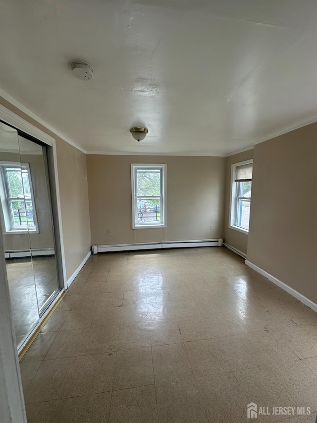 146 Seaman St, New Brunswick, NJ 08901 - unfurnished room featuring a baseboard heating unit, crown molding, a smoke detector, and tile patterned floors