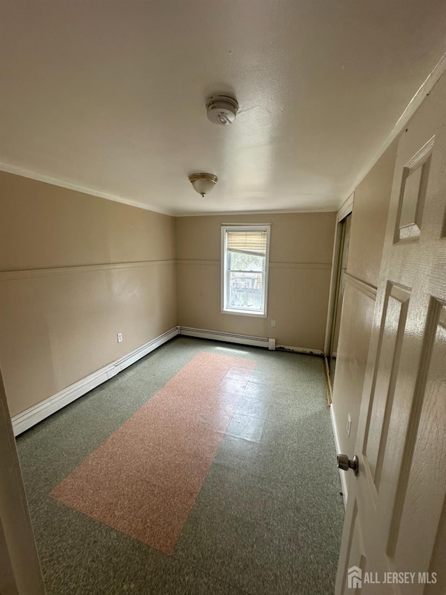 146 Seaman St, New Brunswick, NJ 08901 - spare room featuring baseboard heating, a smoke detector, and ornamental molding