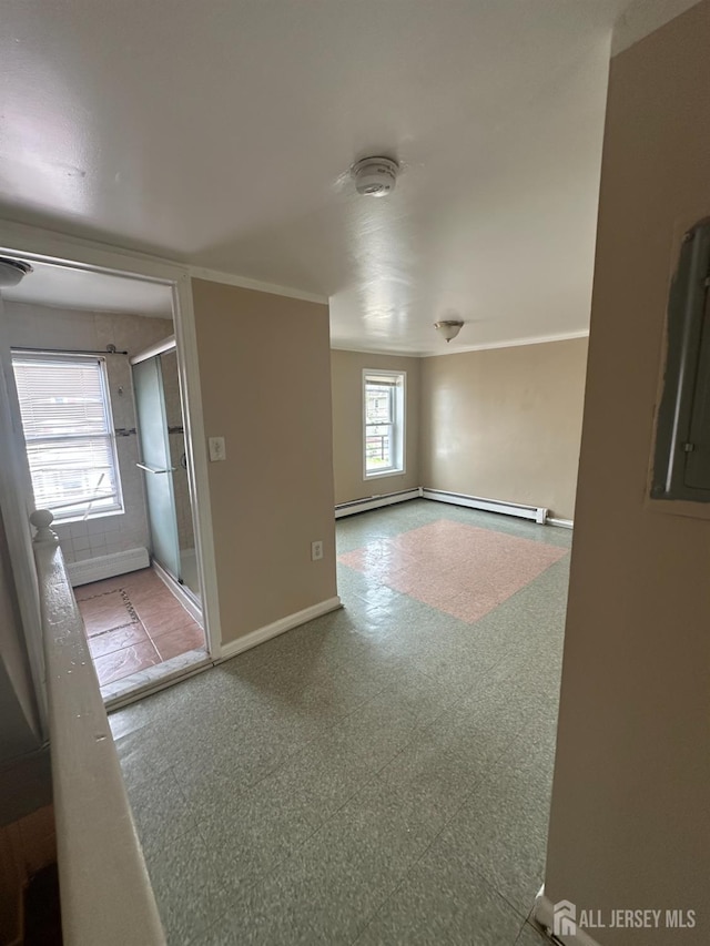 146 Seaman St, New Brunswick, NJ 08901 - empty room featuring tile patterned floors, baseboard heating, and a smoke detector