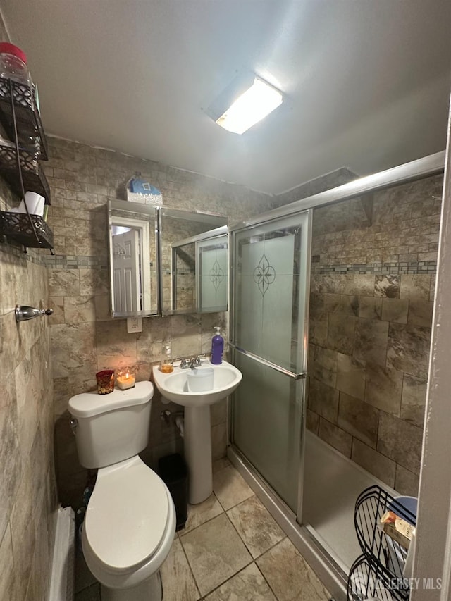 146 Seaman St, New Brunswick, NJ 08901 - bathroom with a stall shower, tile walls, and tile patterned flooring