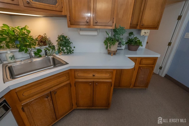 173 N Main St, Milltown, NJ 08850 - kitchen featuring light countertops, brown cabinets, carpet floors, and dishwasher