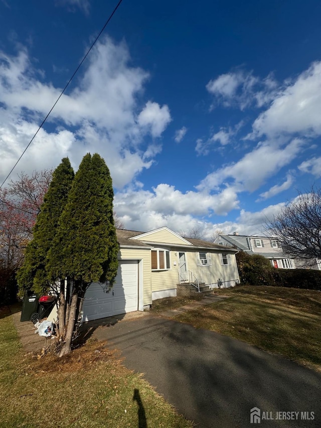 view of front of house with a garage and a front lawn