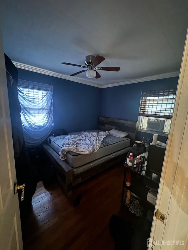 bedroom with cooling unit, hardwood / wood-style floors, crown molding, and ceiling fan