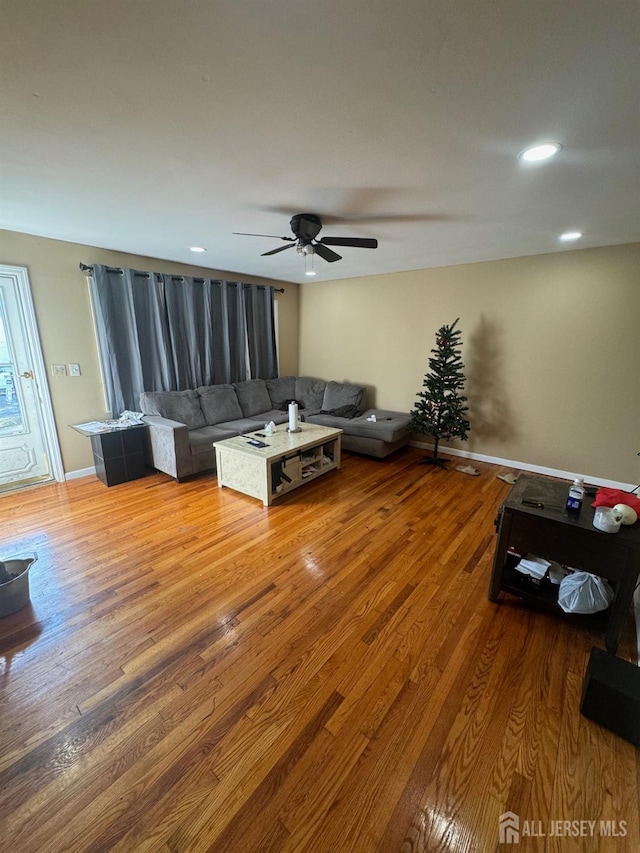 unfurnished living room featuring ceiling fan and hardwood / wood-style floors