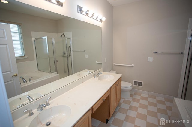 bathroom with tile patterned floors, a stall shower, a bath, double vanity, and toilet