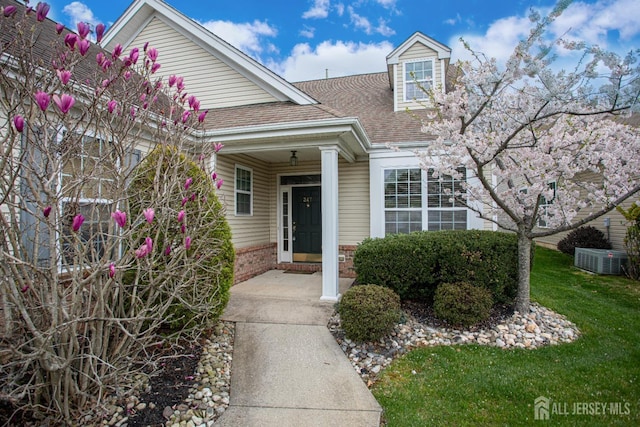247 Springmeadow Way, Monroe, NJ 08831 - view of front of property featuring roof with shingles, brick siding, central AC, and a front lawn