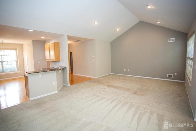 247 Springmeadow Way, Monroe, NJ 08831 - unfurnished living room featuring light colored carpet, baseboards, recessed lighting, lofted ceiling, and a chandelier