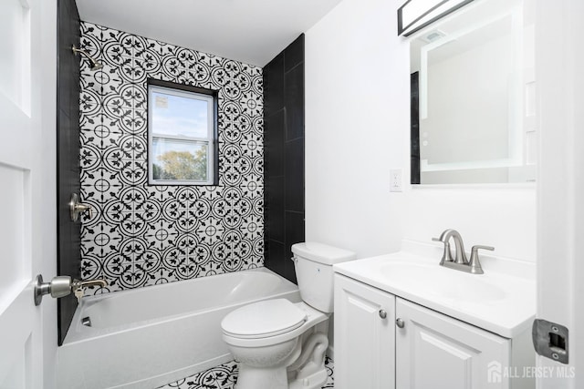 full bathroom featuring toilet, vanity, and tiled shower / bath