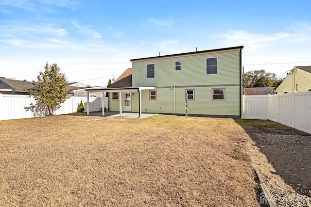 back of house featuring a yard and a patio