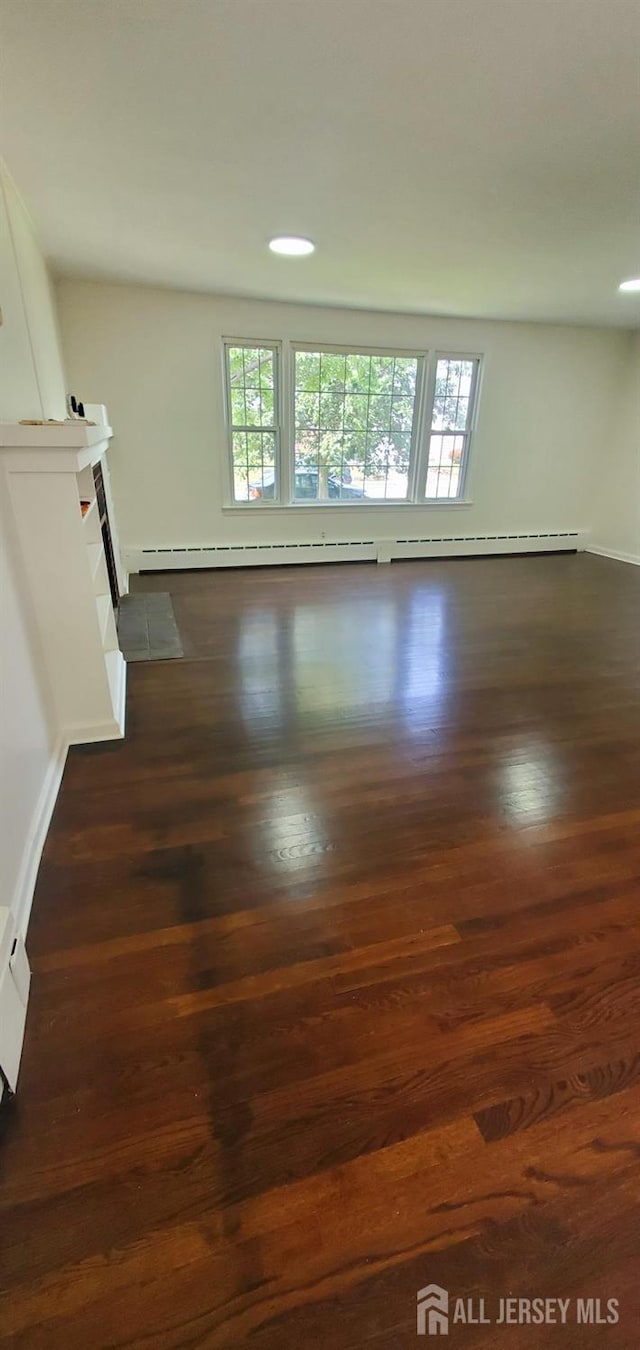 308 Codrington Pl, Bound Brook, NJ 08805 - unfurnished living room with dark wood-style flooring and baseboard heating