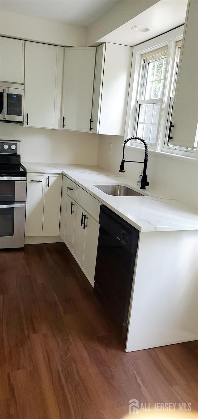 308 Codrington Pl, Bound Brook, NJ 08805 - kitchen with stainless steel appliances, light countertops, dark wood-type flooring, and white cabinetry