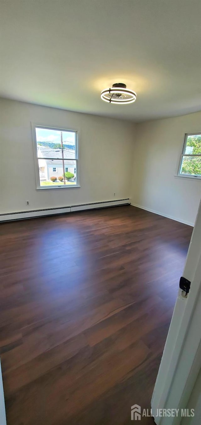 308 Codrington Pl, Bound Brook, NJ 08805 - unfurnished room with a baseboard heating unit and dark wood finished floors
