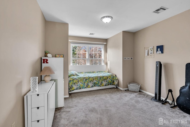 bedroom featuring light carpet, visible vents, and baseboards