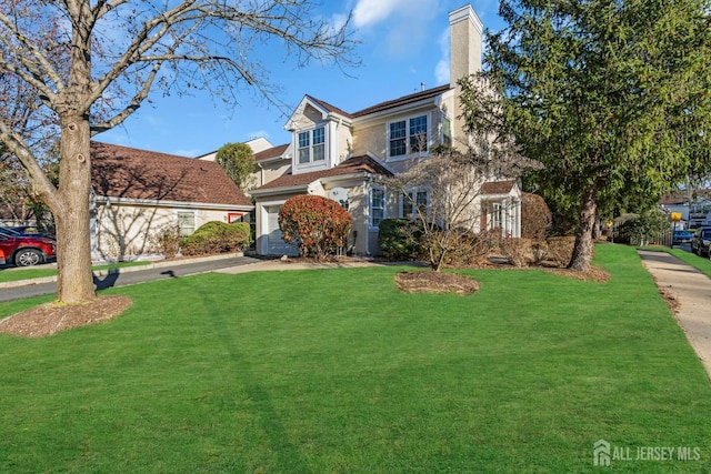 view of front of home featuring a garage, a chimney, a front lawn, and stucco siding