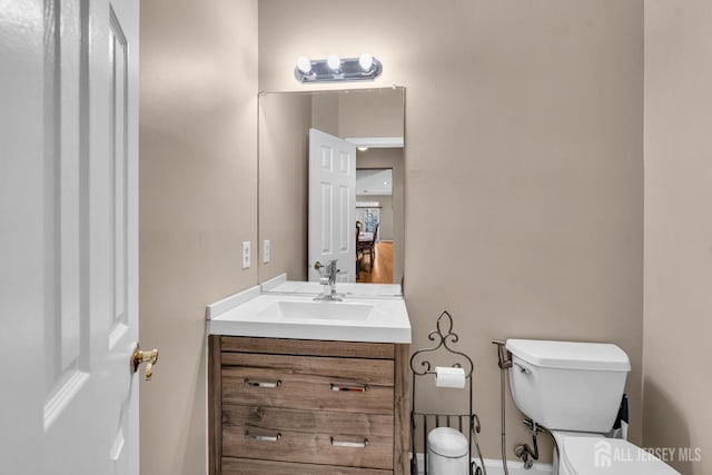 bathroom with toilet and vanity