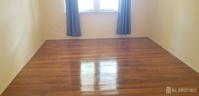 spare room featuring dark hardwood / wood-style flooring