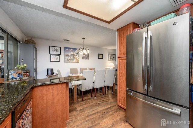 109-B Hemlock Plz, Monroe, NJ 08831 - kitchen with freestanding refrigerator, brown cabinetry, light wood-style floors, a chandelier, and dark stone countertops