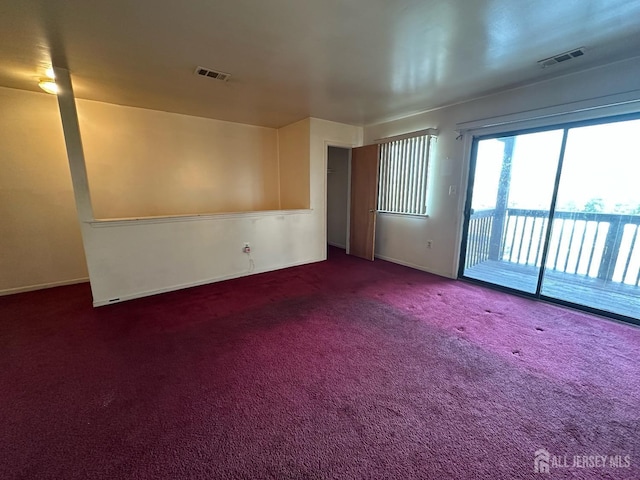 unfurnished room featuring visible vents and carpet