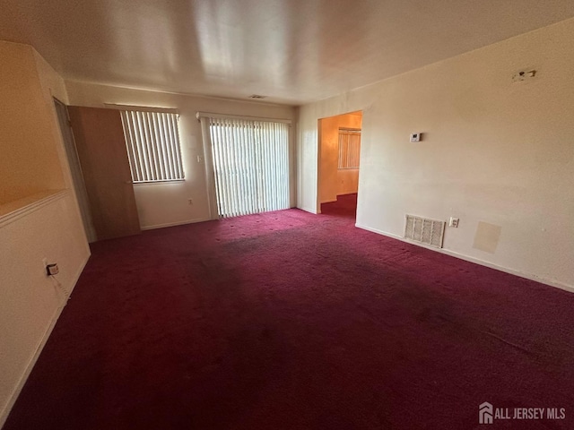 spare room with visible vents and carpet floors