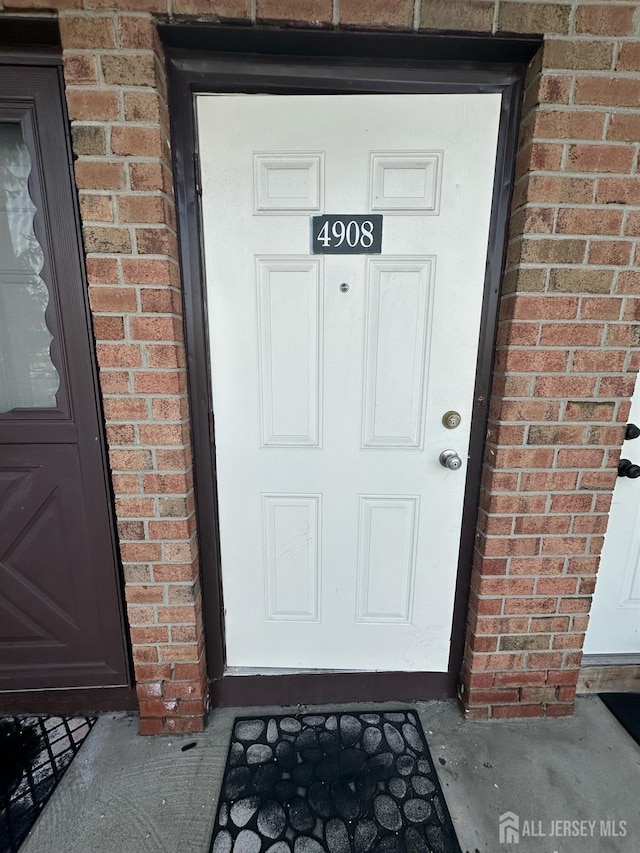 property entrance with brick siding