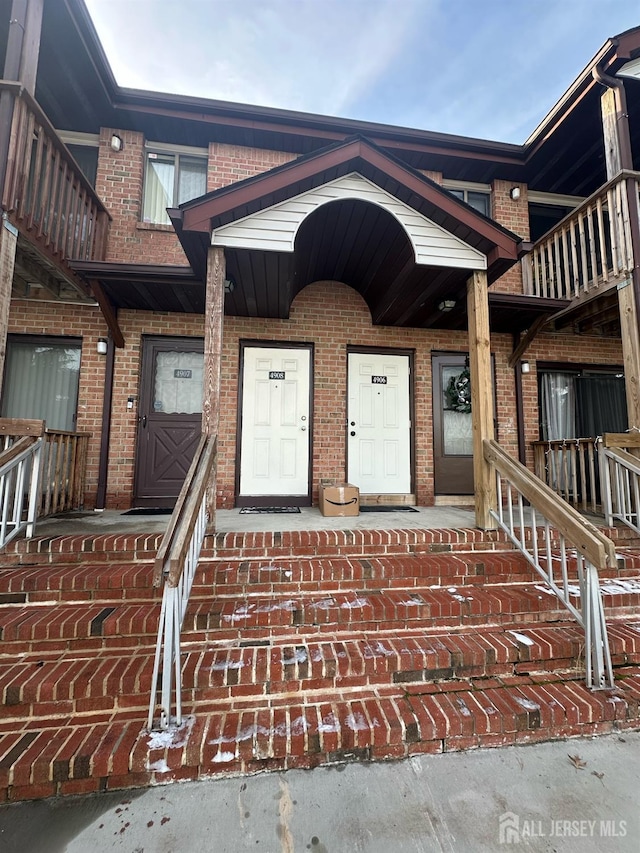 property entrance with brick siding