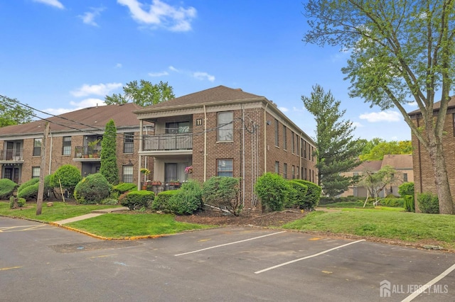 323 Gill Ln Unit 11Q, Iselin, NJ 07067 - view of building exterior with uncovered parking