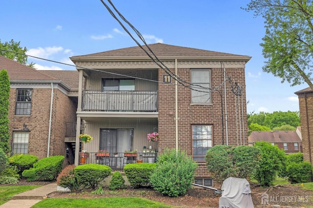 323 Gill Ln Unit 11Q, Iselin, NJ 07067 - rear view of house featuring a balcony and brick siding