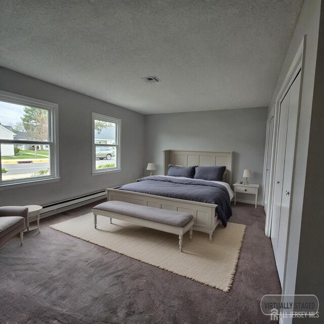467 New Haven Way Unit A, Monroe, NJ 08831 - carpeted bedroom featuring a baseboard radiator, a textured ceiling, and a closet