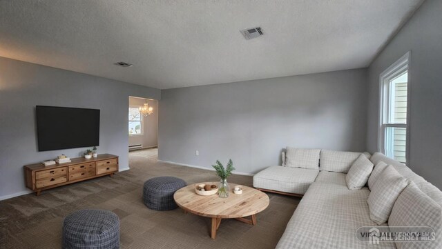 467 New Haven Way Unit A, Monroe, NJ 08831 - carpeted living area featuring a chandelier, baseboard heating, baseboards, and a textured ceiling