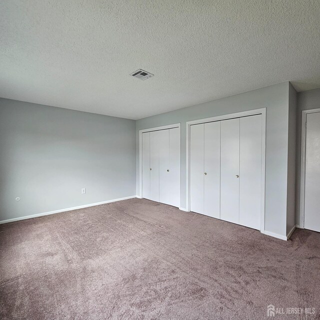 467 New Haven Way Unit A, Monroe, NJ 08831 - unfurnished bedroom with carpet, multiple closets, a textured ceiling, and baseboards