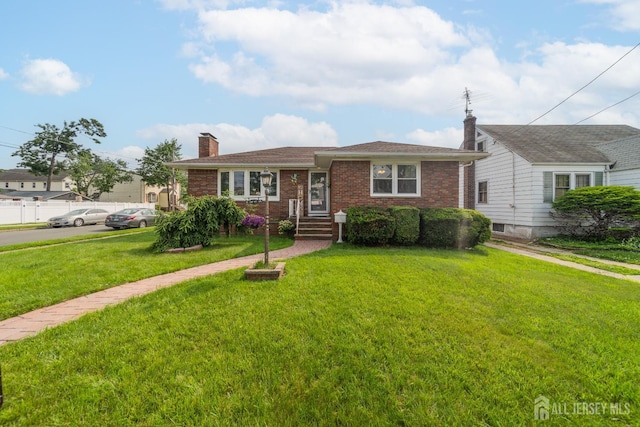 119 Carteret Ave, Carteret, NJ 07008 - view of front of property with a chimney, a front lawn, and brick siding