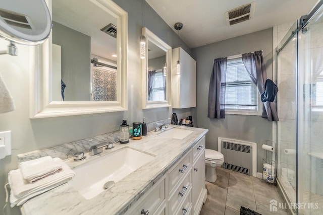 119 Carteret Ave, Carteret, NJ 07008 - bathroom featuring radiator, a shower stall, double vanity, and tile patterned floors