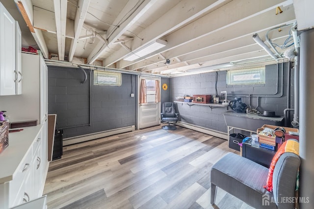 119 Carteret Ave, Carteret, NJ 07008 - below grade area with baseboard heating, plenty of natural light, and light wood-style floors