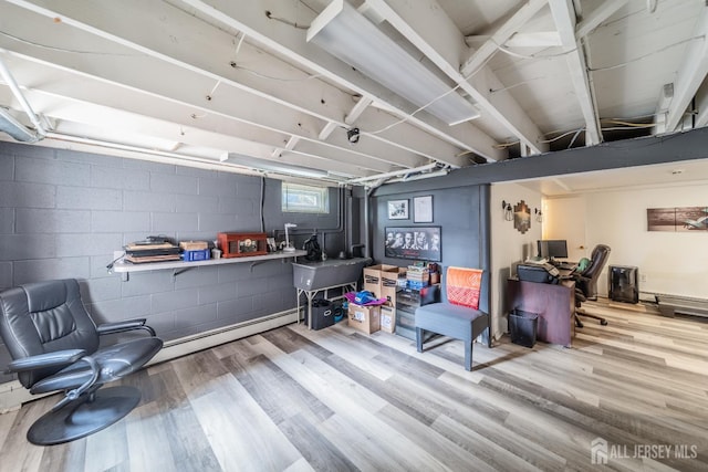 119 Carteret Ave, Carteret, NJ 07008 - below grade area with wood finished floors, a baseboard heating unit, and concrete block wall