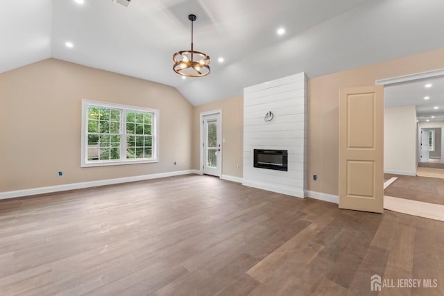 38 Louise Dr, East Brunswick, NJ 08850 - unfurnished living room featuring lofted ceiling, a chandelier, a fireplace, wood finished floors, and recessed lighting