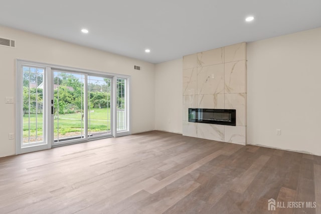 38 Louise Dr, East Brunswick, NJ 08850 - unfurnished living room featuring wood finished floors, a high end fireplace, recessed lighting, and heating unit
