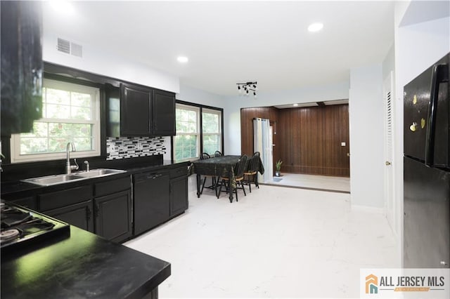 11 Gunpowder Dr, East Brunswick, NJ 08816 - kitchen with black appliances, dark countertops, backsplash, recessed lighting, and wood walls