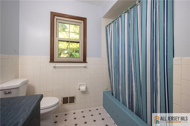 11 Gunpowder Dr, East Brunswick, NJ 08816 - full bathroom featuring tile walls, a wainscoted wall, vanity, and shower / bath combo