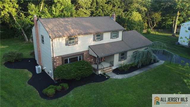 11 Gunpowder Dr, East Brunswick, NJ 08816 - view of front of property featuring a chimney, a front yard, a porch, and brick siding