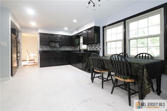 11 Gunpowder Dr, East Brunswick, NJ 08816 - kitchen featuring dark cabinets, black microwave, tasteful backsplash, freestanding refrigerator, and light marble finish flooring