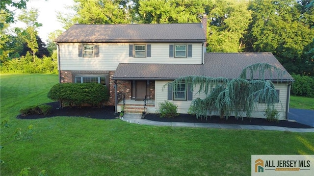 11 Gunpowder Dr, East Brunswick, NJ 08816 - view of front of home featuring a front yard, a chimney, brick siding, and a shingled roof