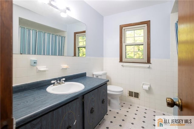 11 Gunpowder Dr, East Brunswick, NJ 08816 - full bathroom featuring tile walls, healthy amount of natural light, vanity, wainscoting, and a shower with shower curtain